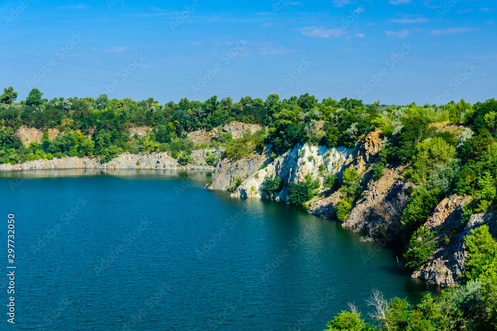 Beautiful lake in the abandoned granite quarry on summer