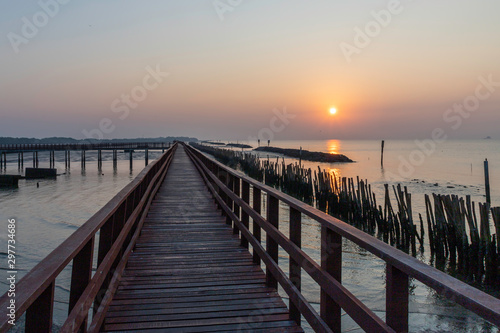Sunrise with red wooden bridge