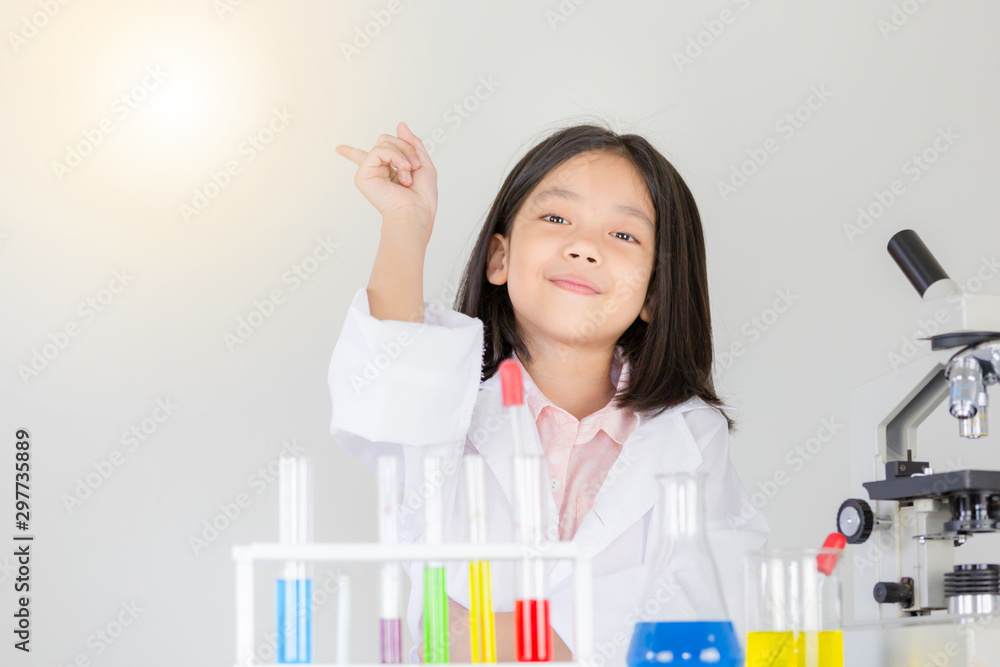 Children scientist concept, Happy little girl is presenting at the laboratory in science classroom Children scientist concept, Happy little girl is presenting at the laboratory in science classroom