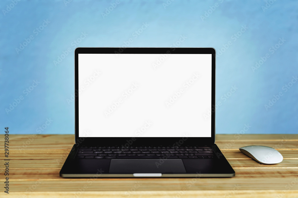 Laptop computer with blank white screen on the table, background wall blur Laptop computer with blank white screen on the table, background wall blur