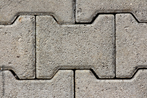 Obraz na plátně Heavily used old densely laid I shaped concrete tiles at path in local public pa
