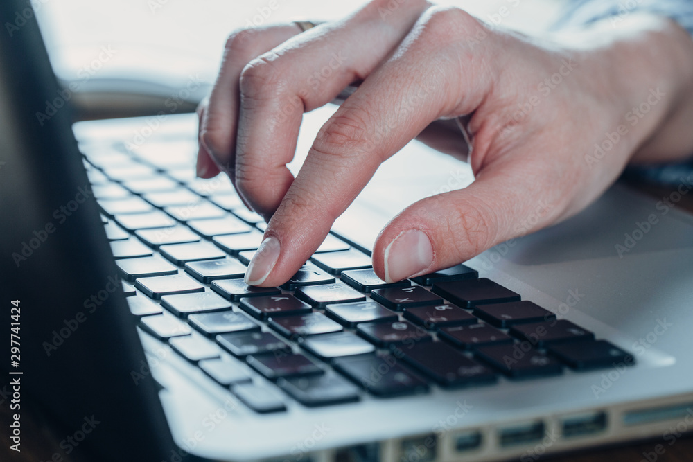 Woman working at home office hand on keyboard close up Woman working at home office hand on keyboard close up