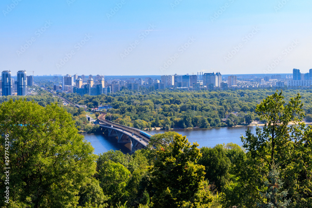 Aerial view of Metro bridge with subway train passing and the Dnieper river in Kiev, Ukraine. Kyiv cityscape