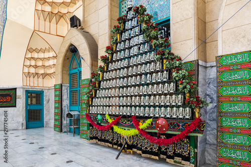 lanterns and Shiite saints' names embroidered and printed on fabrics in front of a mosque, as a symbol of mourning of Imam Husayn martyrdom, Tehran, Iran photo