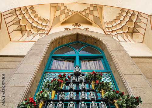 Fotografie, Obraz kerosene lamps and artificial flowers in front of Imam Sadiq mosque entrance, a