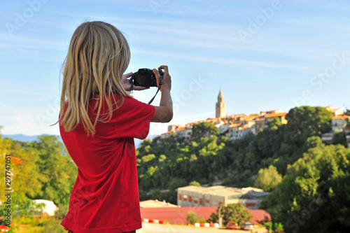 Little traveller taking a shot of Vrbnik town, Croatia