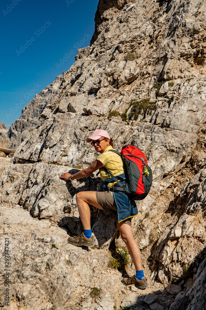 Woman traveling in the Dolomites mountain massif of the Alps