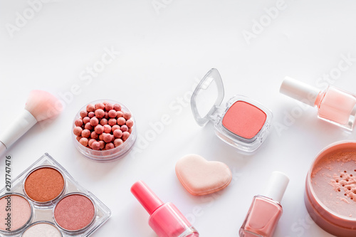 Makeup background with rounge, powder and tools on white table copy space