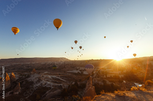 Hot Air Balloon Flight South Cappadocia Tour Goreme Open Air Museum. Flying hot air balloons rise in sunrise Cappadocia. Goreme National Park Turkey.