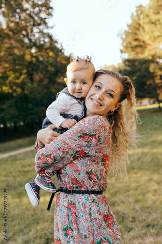 Mother and her child enjoy the sunset outdoor - Image