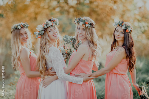 Bild auf Leinwand The bride with the bridesmaids looking at the camera