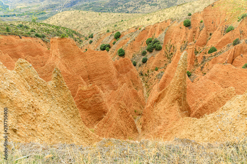 Valley eroded by rain and wind forming ravines in the red clay called Las Carcavas in Madrid photo