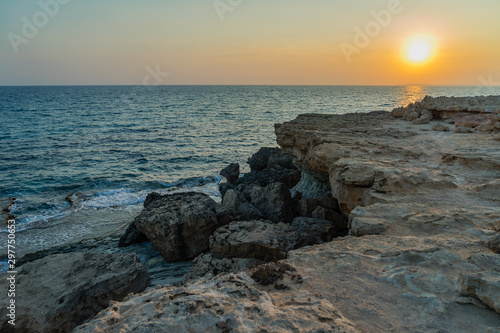 View of rocks with sea caves at sunset on Cape Greco near Ayia NAPA, Cyprus.