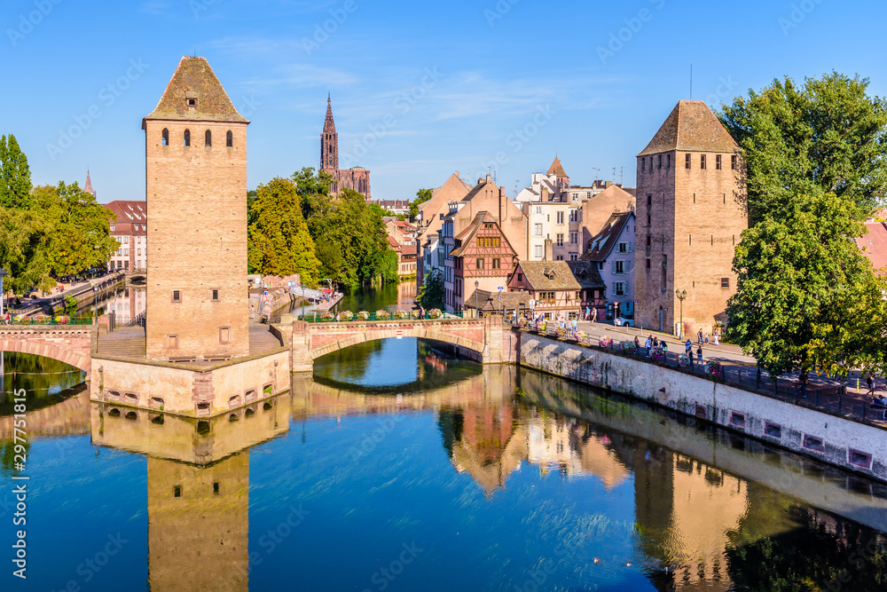 The Ponts Couverts, a medieval set of bridges and towers on the river Ill at the entrance of the Petite France historic quarter in Strasbourg, France, and Notre-Dame cathedral in the distance.