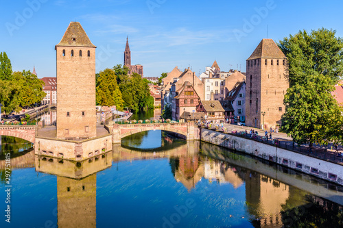 The Ponts Couverts, a medieval set of bridges and towers on the river Ill at the entrance of the Petite France historic quarter in Strasbourg, France, and Notre-Dame cathedral in the distance. © olrat