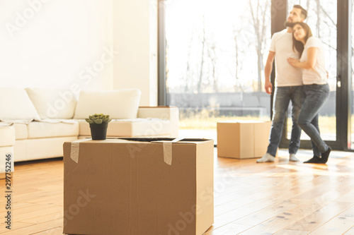 young couple moves to a new home. the family carries boxes of things after buying a home.