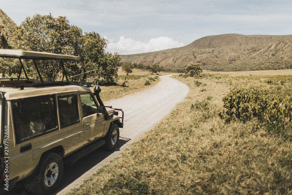 Safari in Hell's Gate national park in Kenya. Off road jeep car, savanna and mountain view. Explore wilderness of Africa.