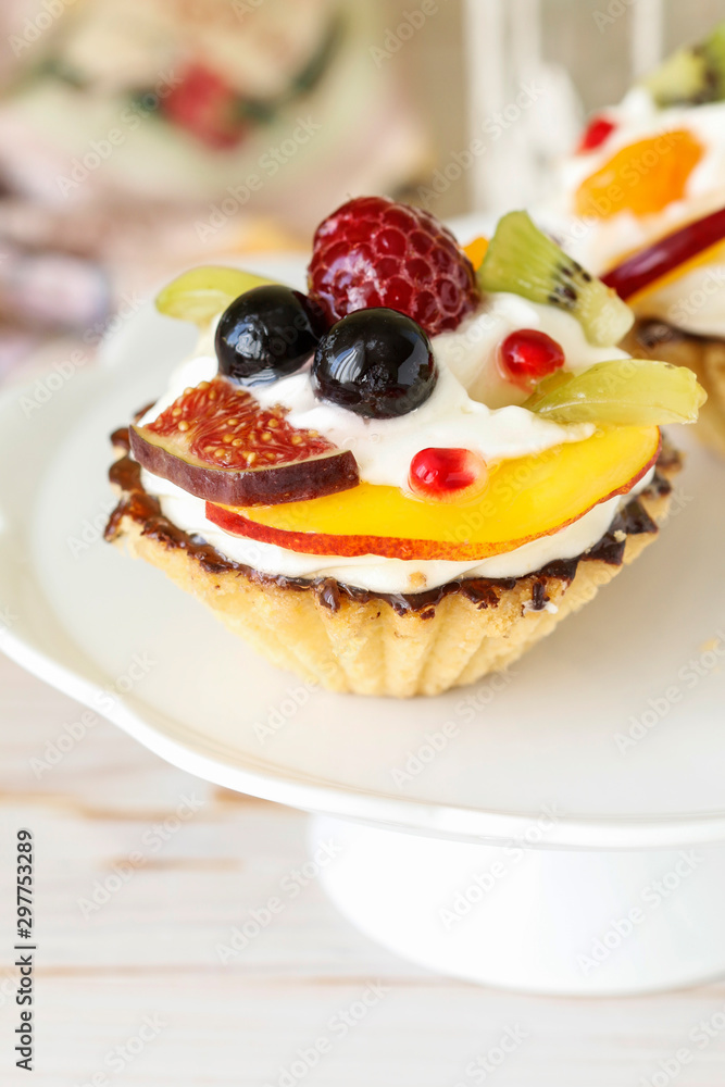 Beautiful cupcakes decorated with fresh fruits: grapes, peach, orange. Beautiful cupcakes decorated with fresh fruits: grapes, peach, orange.