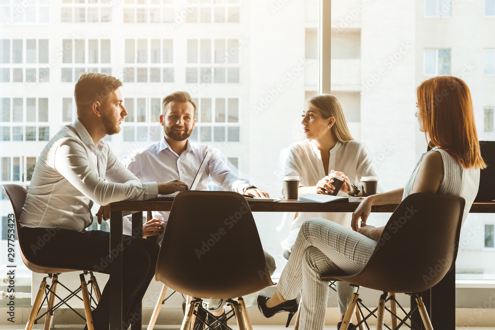A team of young businessmen working and communicating together in an office. Corporate businessteam and manager in a meeting. A team of young businessmen working and communicating together in an office. Corporate businessteam and manager in a meeting.