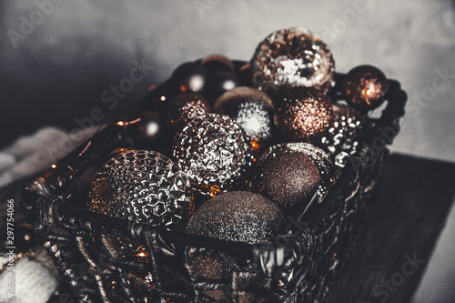 vintage christmas  new Year toys and decoration in basket on brown wooden table with garlands  copy space