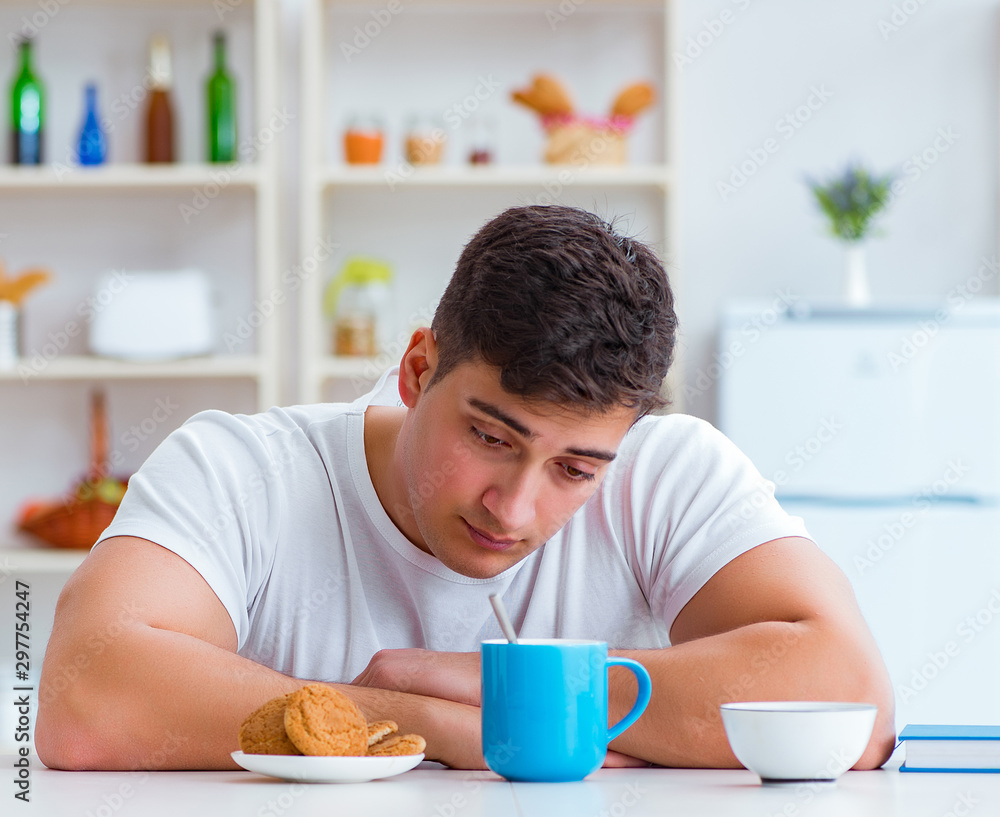 Man falling asleep during his breakfast after overtime work Man falling asleep during his breakfast after overtime work