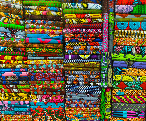 Stacks of bright colorful fabrics. Shopping, consumerism concept