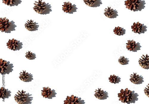 Christmas or New Year concept frame with pine cones on the white background. Top view. Copy space