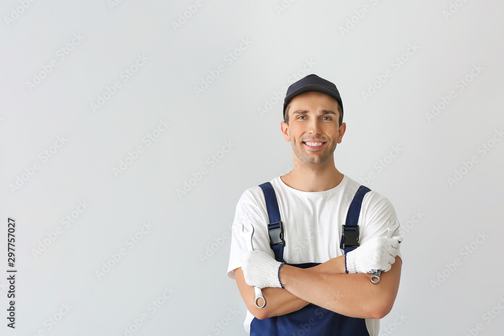 Male car mechanic on light background Male car mechanic on light background
