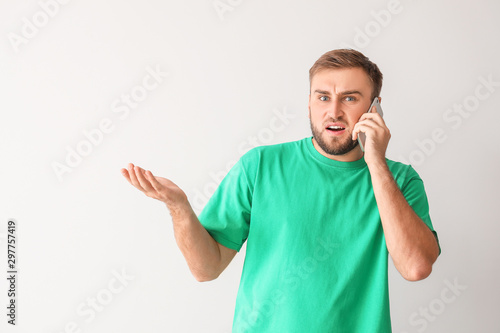 Confused young man talking ...