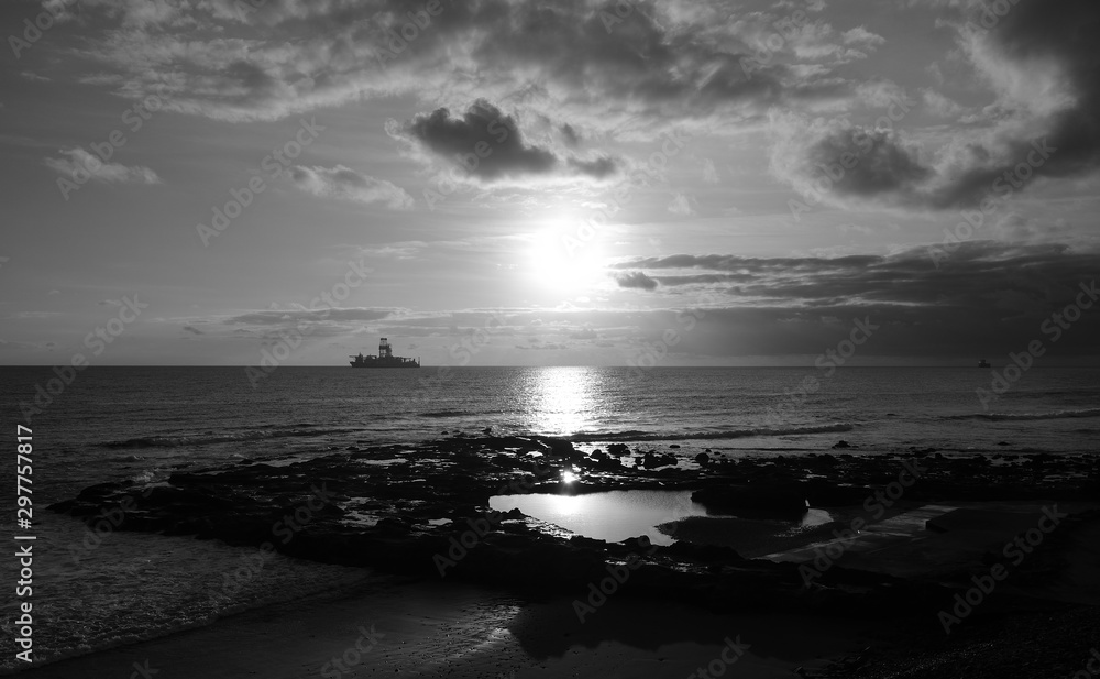 Beautiful sunrise from the natural pool of La Laja, coast of Gran Canaria, Canary Islands, black and white effect Beautiful sunrise from the natural pool of La Laja, coast of Gran Canaria, Canary Islands, black and white effect