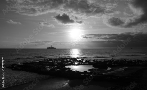 Beautiful sunrise from the natural pool of La Laja, coast of Gran Canaria, Canary Islands, black and white effect 