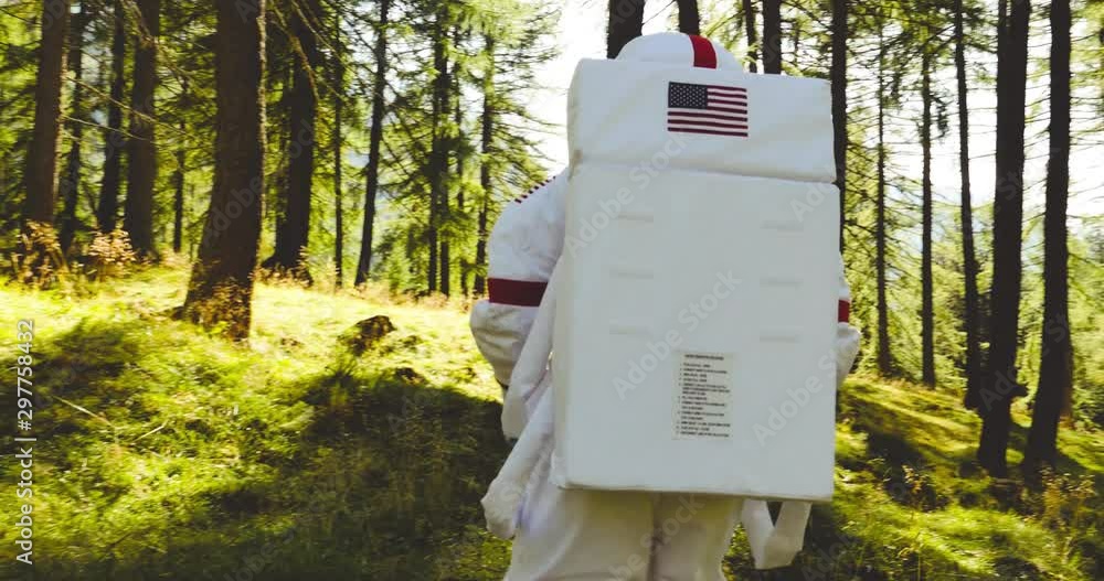 Astronaut has find a new planet similar to earth with nature and forests Astronaut has find a new planet similar to earth with nature and forests