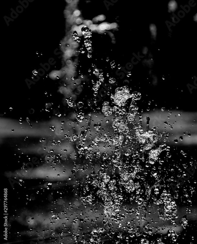 drops of water with splashes on a black background
