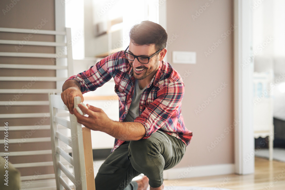 Assembling a wooden crib for baby