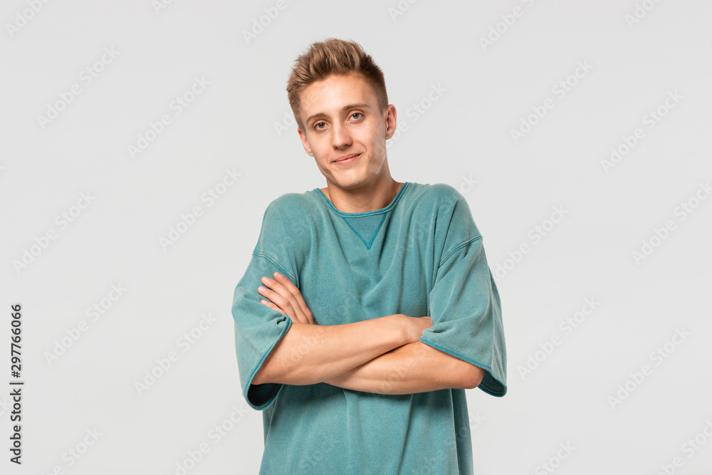 Young pretty man in a green tee shrugging shoulders being helpless. Young pretty man in a green tee shrugging shoulders being helpless.