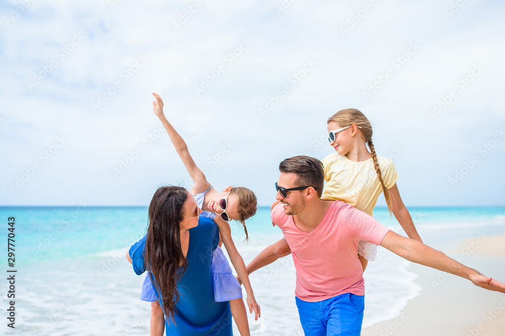 Happy family on the beach during summer vacation