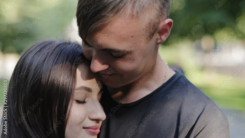 Cheerful, happy, loving couple cuddling tenderly in the city alley.slow-mo Cheerful, happy, loving couple cuddling tenderly in the city alley.slow-mo