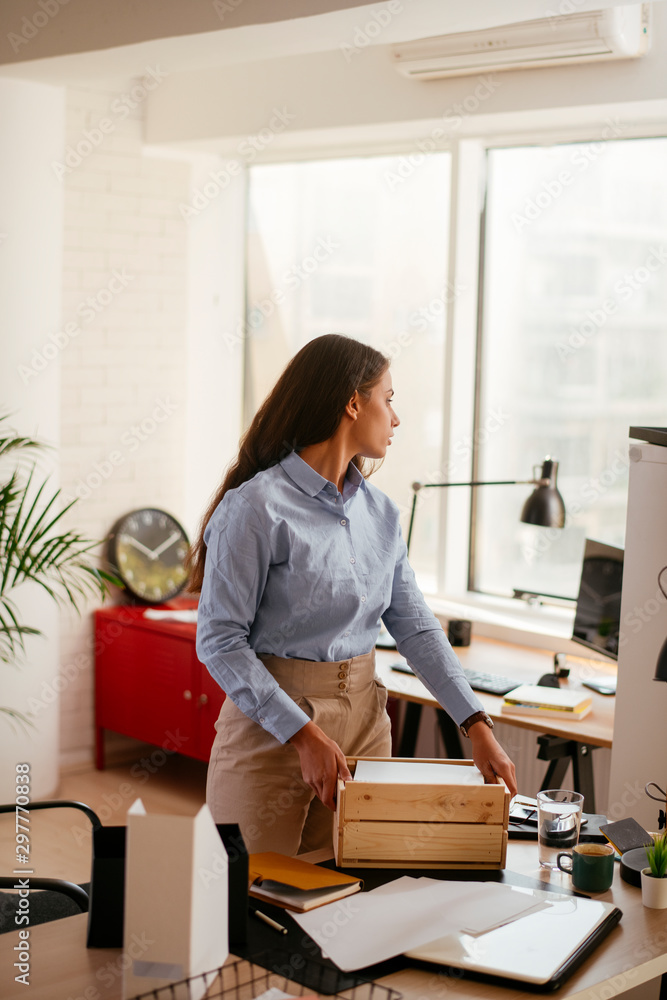 Young businesswoman in office organizing documents Young businesswoman in office organizing documents
