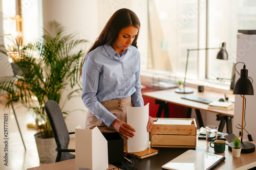 Young businesswoman in office organizing documents photo