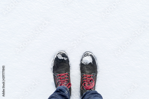 Top view of shoes / boots footprint in fresh snow. Winter season.