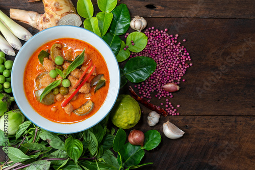  Red Curry Chicken with  ingredients  for cooking  on wood background. ,Thai name kang pad, spicy curry, top view