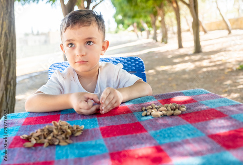 Happy arabic enjoyong eating pistachio in the park outdoor photo