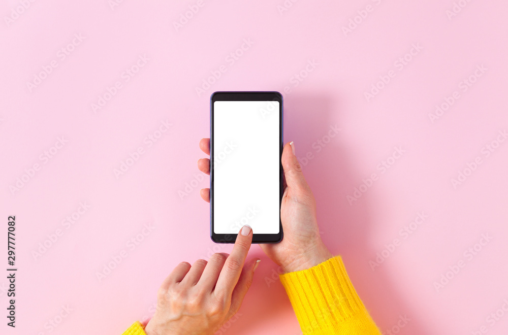 Female hand holding smartphone with blank screen Female hand holding smartphone with blank screen