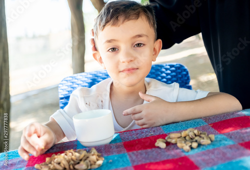 Happy arabic enjoyong eating pistachio in the park outdoor photo