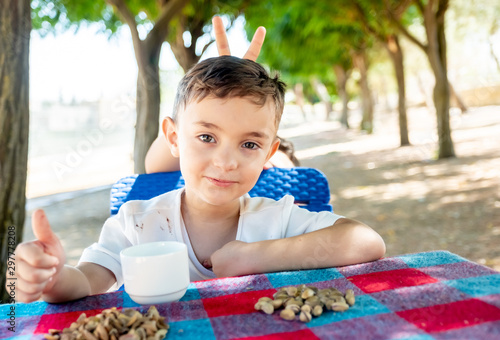 Happy arabic enjoyong eating pistachio in the park outdoor photo