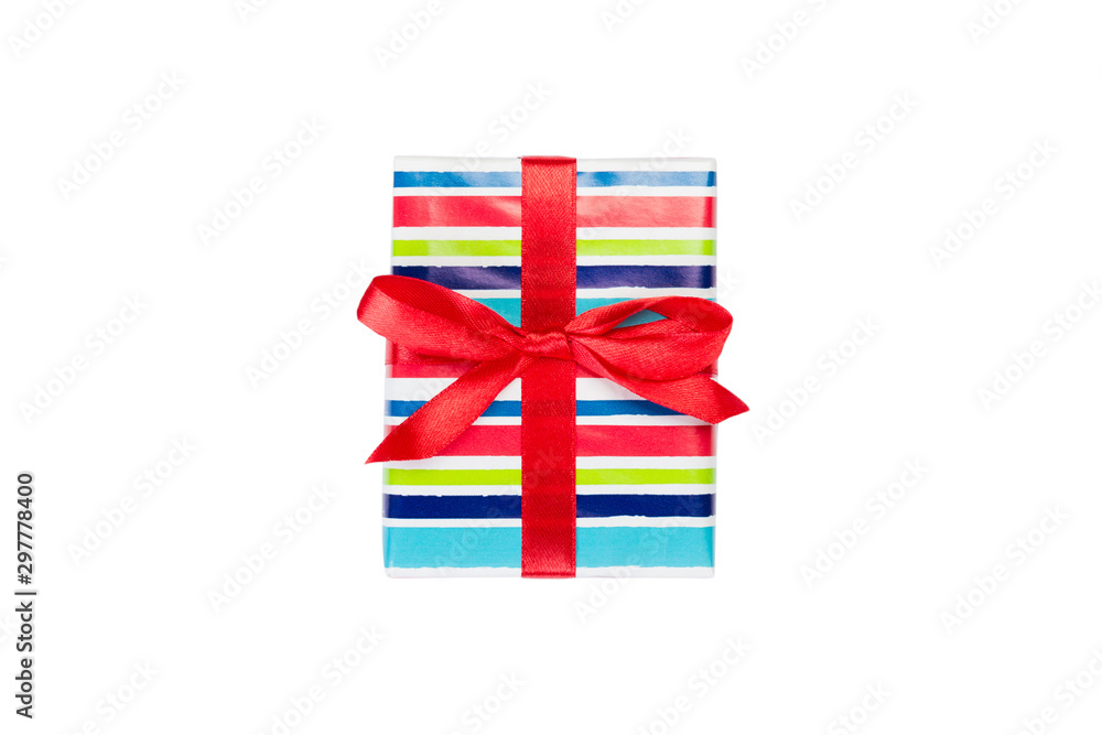 Fototapeta premium Christmas or other holiday handmade present in colored paper with red ribbon. Isolated on white background, top view. thanksgiving Gift box concept
