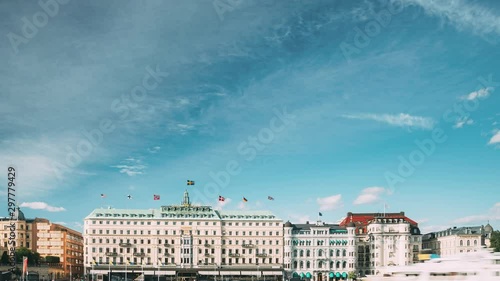 Stockholm, Sweden - June 28, 2019: Grand Hotel Located On The Peninsula Blasieholmen. Touristic Pleasure Boats Floating Near Famous Grand Hotel In Sunny Summer Day