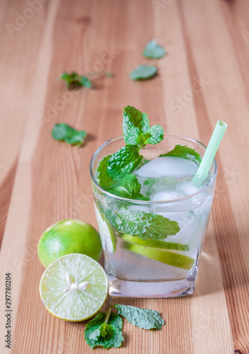 lemonade with mint and lime on wooden table