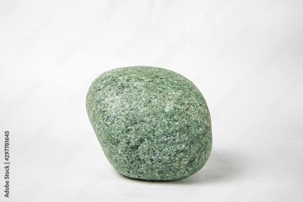 one green smooth stone on a white background one green smooth stone on a white background