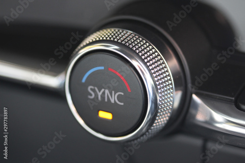 SYNC button and temperature knob in luxury vehicle